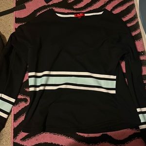 A black long sleeve shirt with white and mint green wording